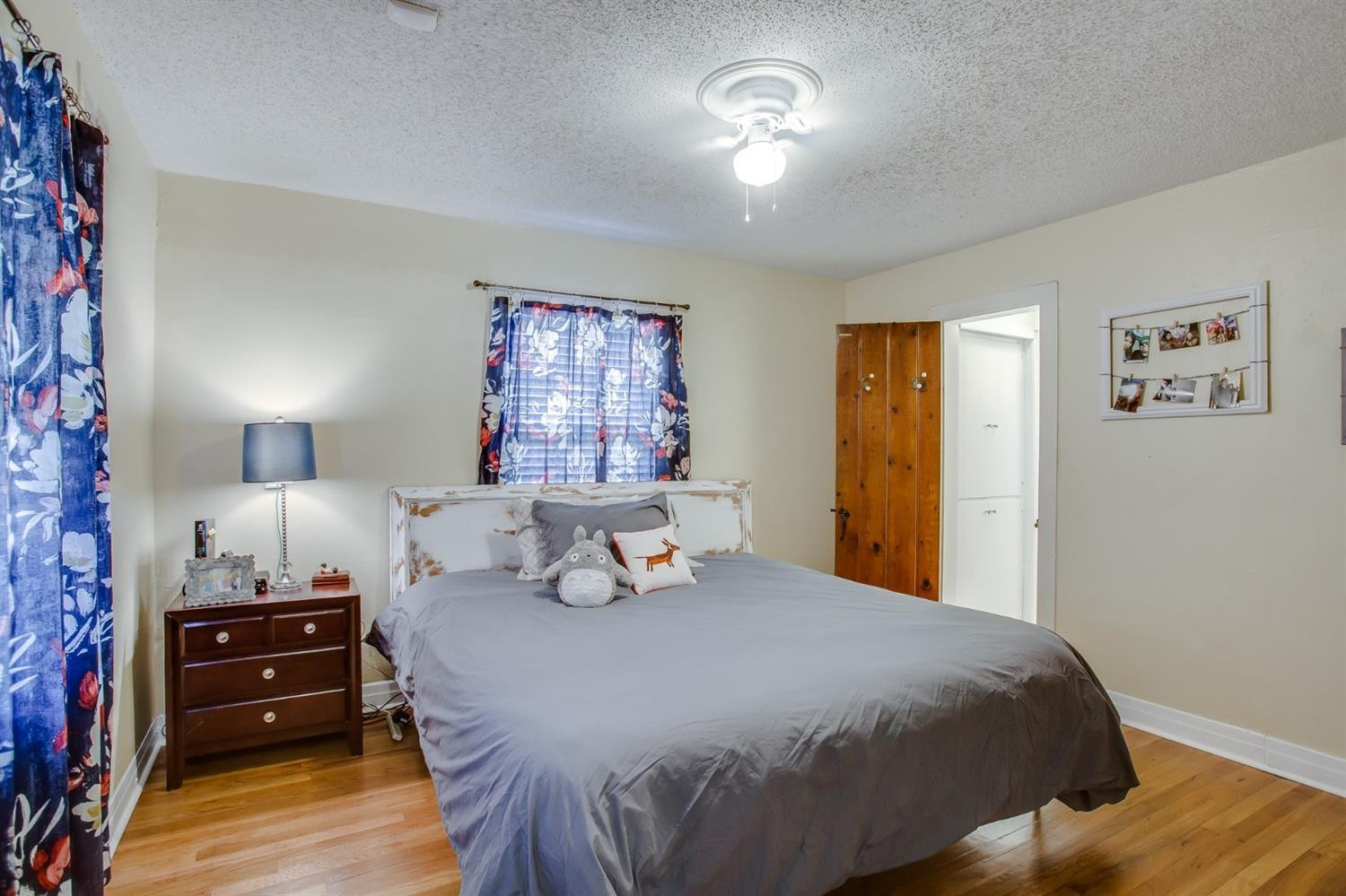 2515 25th Street Lubbock, TX 79410 - Photo 11 of 16 a bedroom with a bed and a chandelier