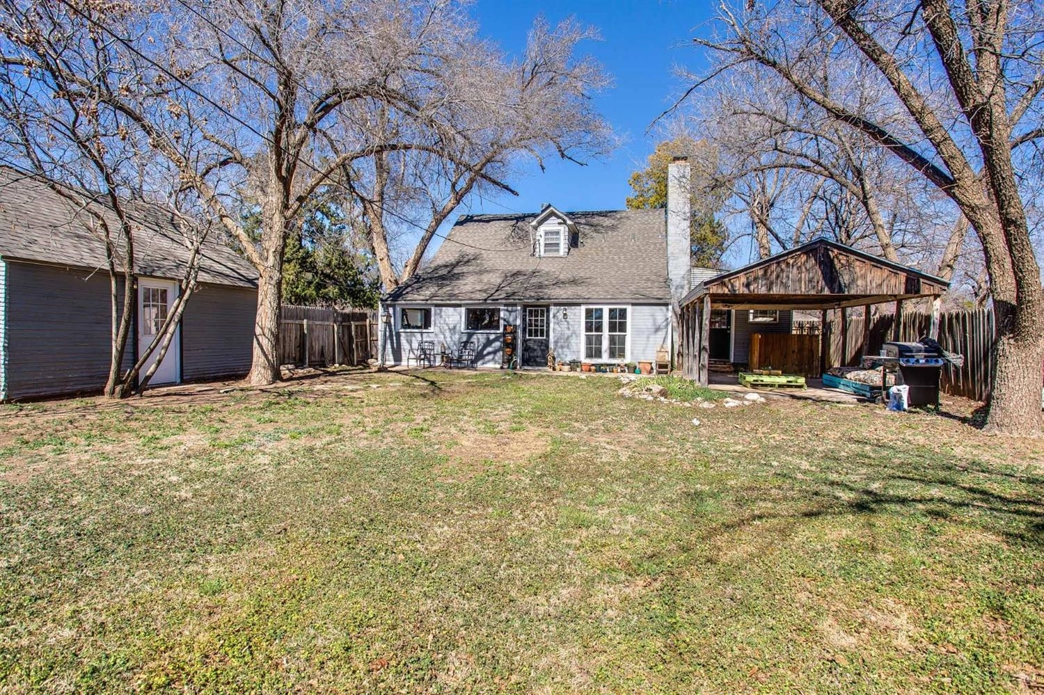 2515 25th Street Lubbock, TX 79410 - Photo 16 of 16 a view of a house with a yard covered with snow and trees