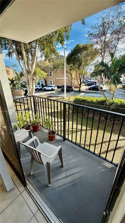 a view of a chairs and table in the balcony