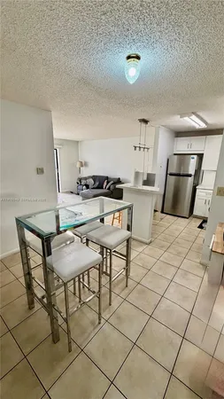 a kitchen with a table chairs and a stove