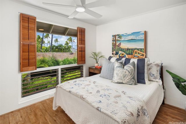 a bedroom with a bed and a wooden floor