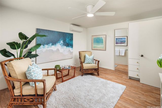 a living room with furniture and a dining table