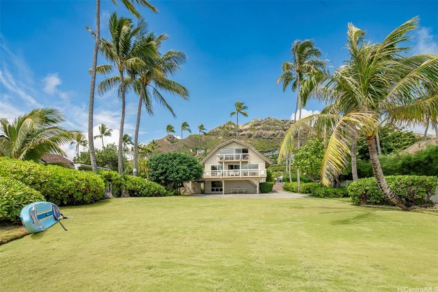 a front view of a house with a big yard