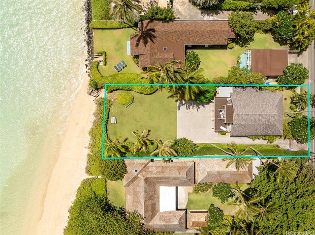 a living room with furniture floor to ceiling window and wooden floor