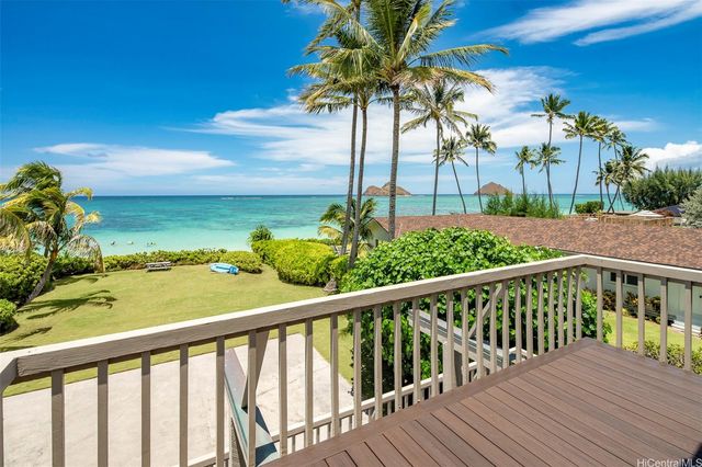 a bedroom with furniture and a large window