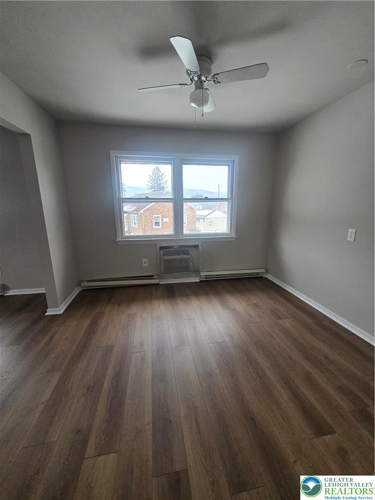 188 Jefferson Street, Unit 2 Emmaus, PA 18049 - Photo 4 of 9 an empty room with wooden floor and windows