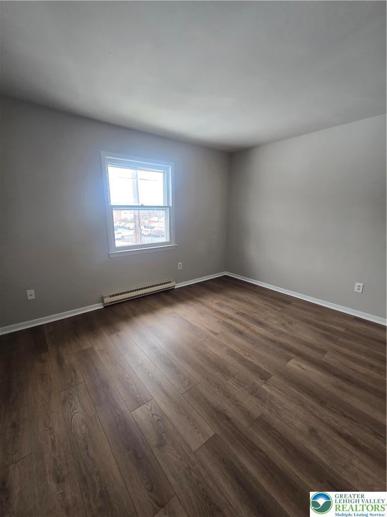 188 Jefferson Street, Unit 2 Emmaus, PA 18049 - Photo 5 of 9 an empty room with wooden floor and windows