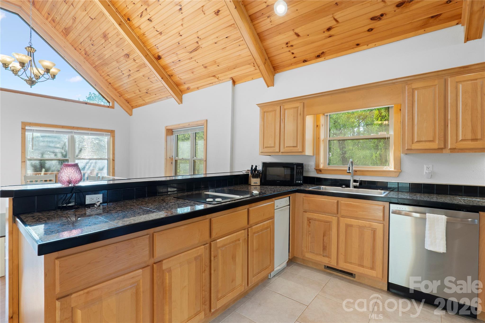 273 North Rhododendron Road Almond, NC 28702 - Photo 12 of 27 a kitchen with granite countertop a sink and white cabinets
