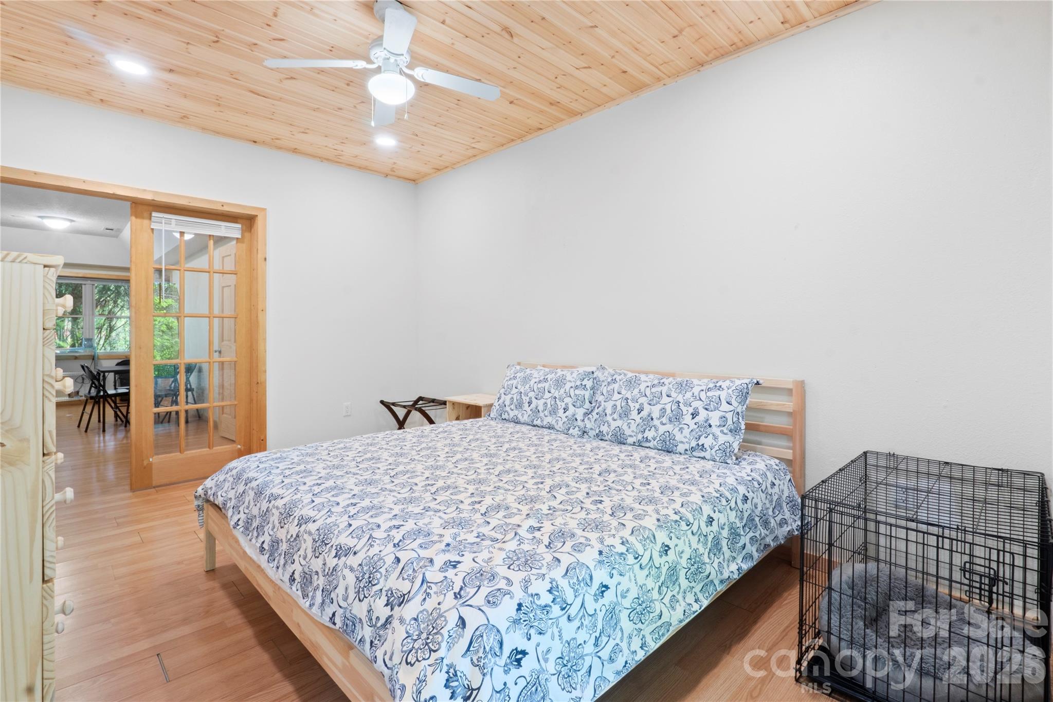 273 North Rhododendron Road Almond, NC 28702 - Photo 19 of 27 a bedroom with a large bed and a chandelier