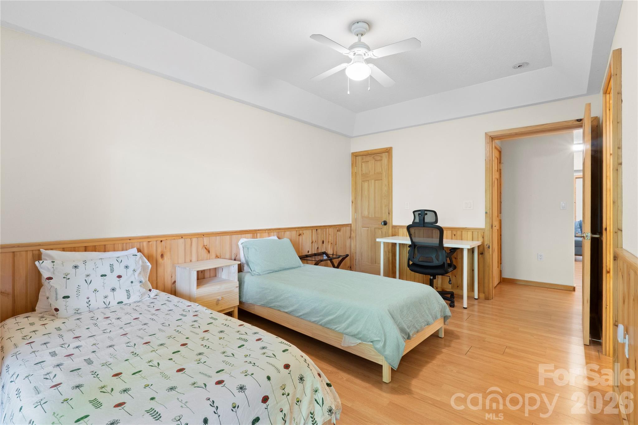 273 North Rhododendron Road Almond, NC 28702 - Photo 25 of 27 a bedroom with a large bed and a chandelier