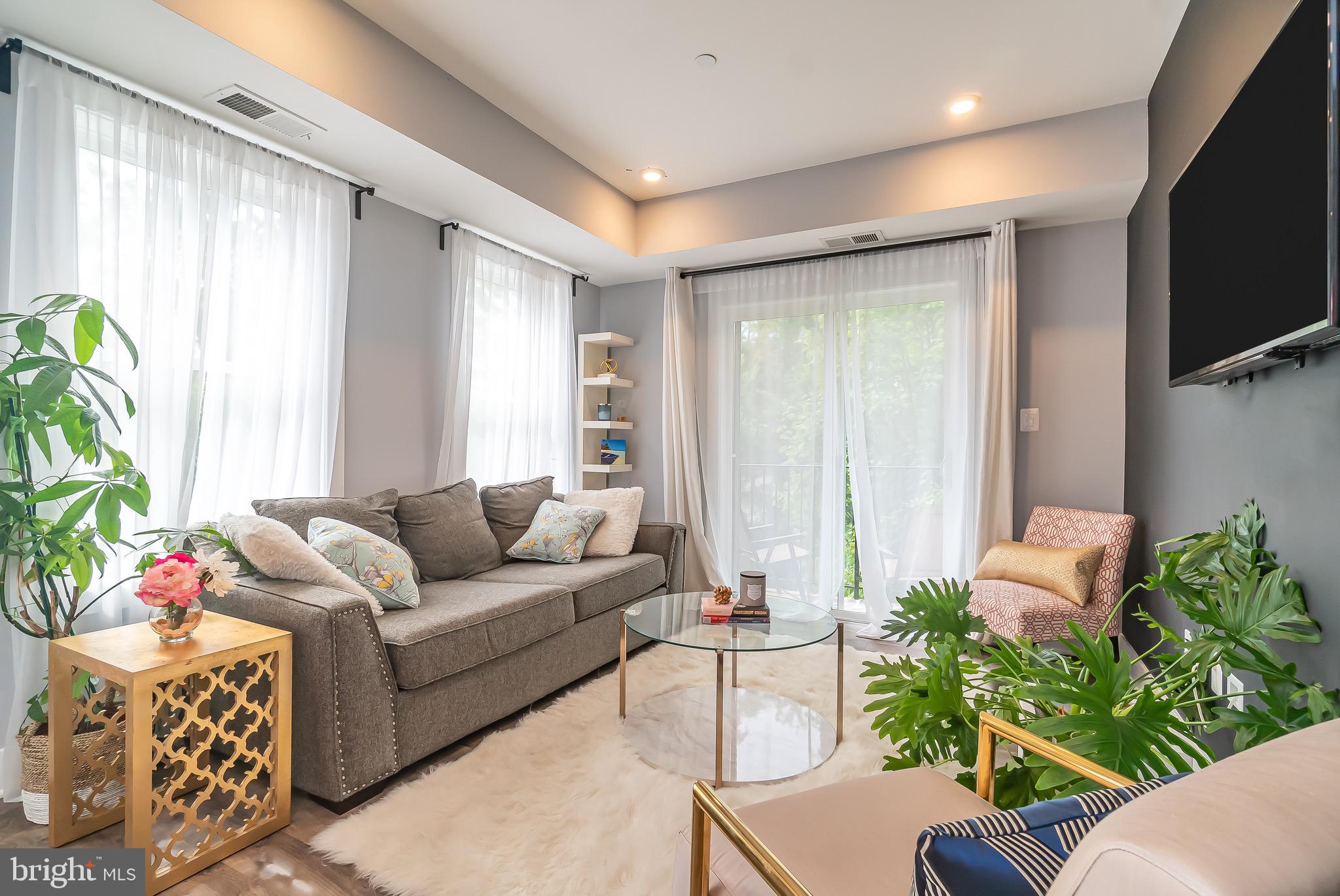 a living room with furniture potted plant and a window