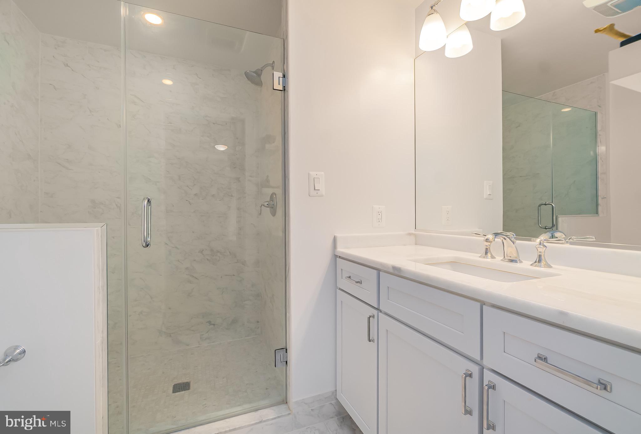 1340 Nicholson Street Northwest, Unit 5 Washington, DC 20011 - Photo 17 of 27 a bathroom with a granite countertop sink mirror and shower