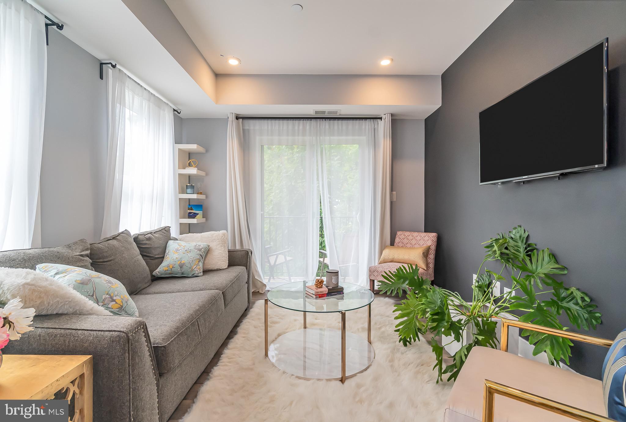 1340 Nicholson Street Northwest, Unit 5 Washington, DC 20011 - Photo 2 of 27 a living room with furniture and a flat screen tv