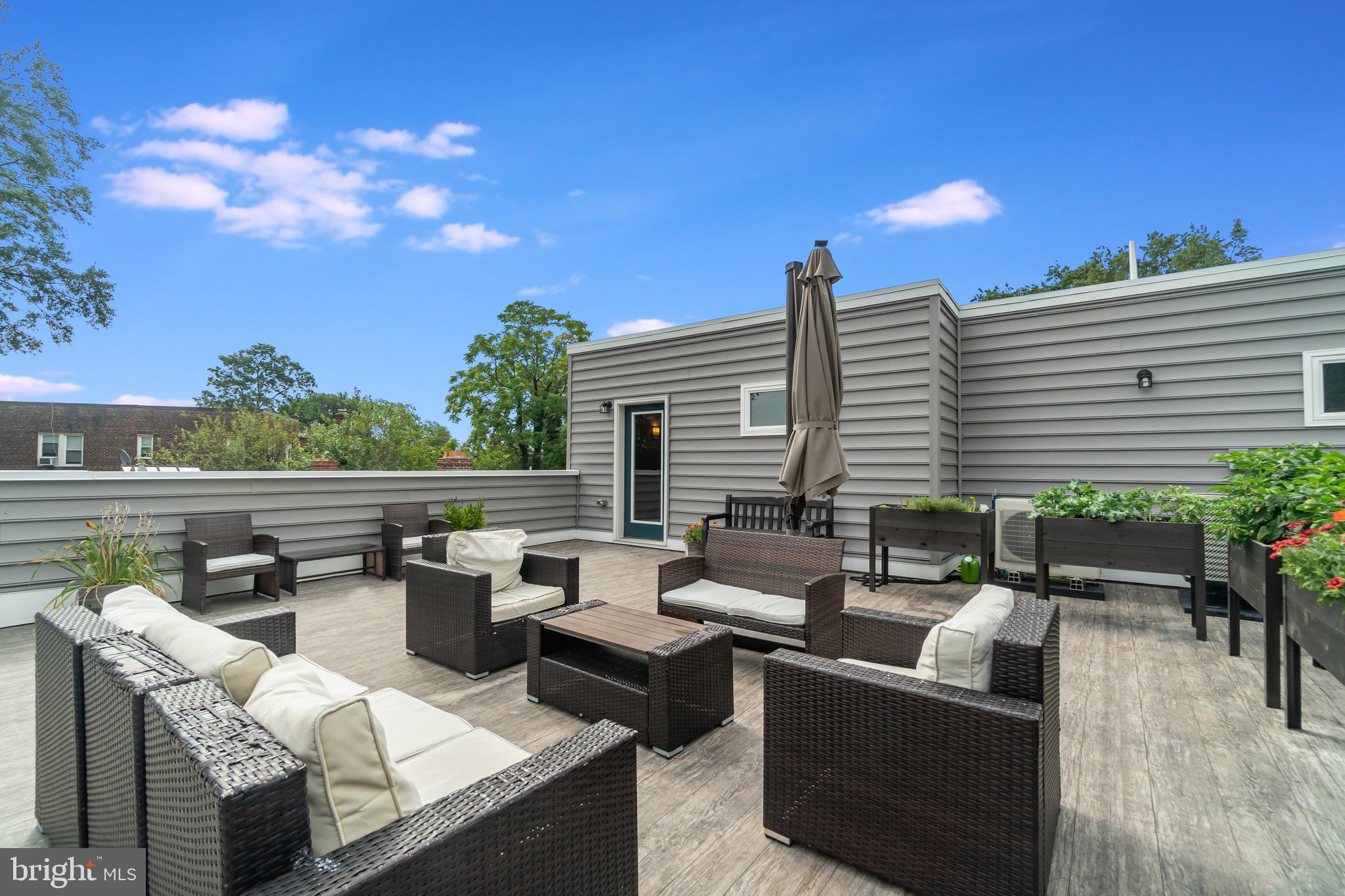 1340 Nicholson Street Northwest, Unit 5 Washington, DC 20011 - Photo 24 of 27 a roof deck with couches and potted plants