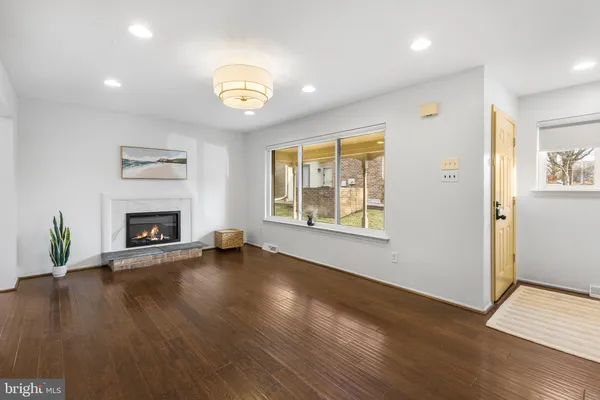 an empty room with windows and a fireplace