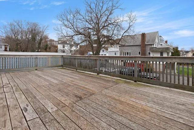 a view of balcony with wooden floor and fence