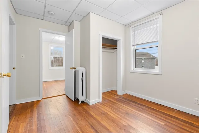 a view of empty room with wooden floor