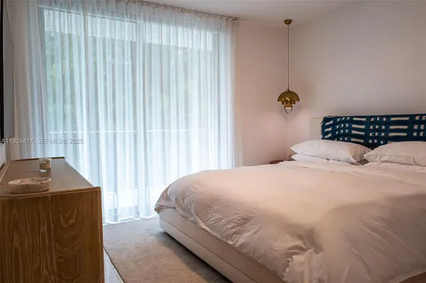 a large white bed in a white room