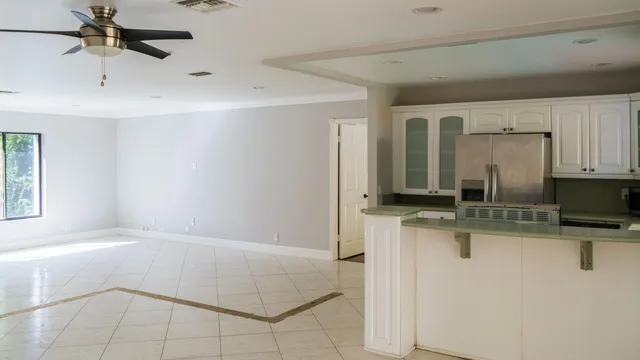 a spacious bathroom with a granite countertop sink a mirror and vanity