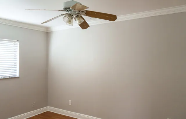 a view of a small space with a fan and a window