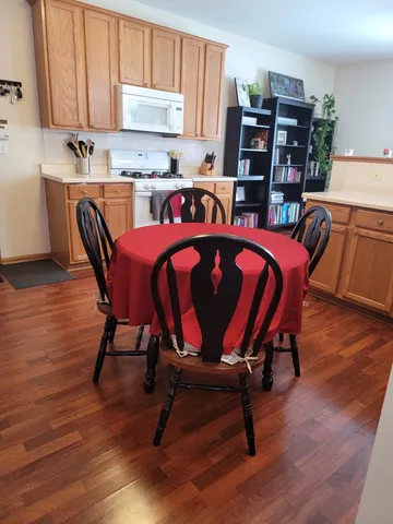 a kitchen with a dining table chairs and cabinets
