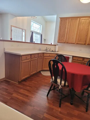 a view of a kitchen counter space and wooden floor