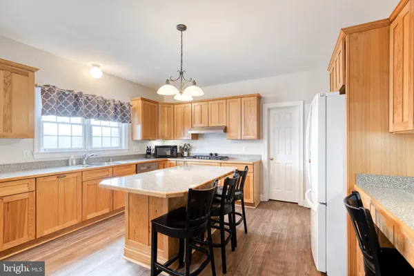a large kitchen with a table and chairs in it
