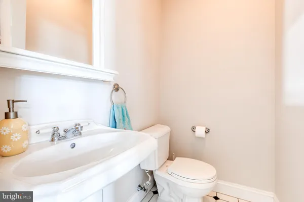 a bathroom with a sink a toilet and mirror