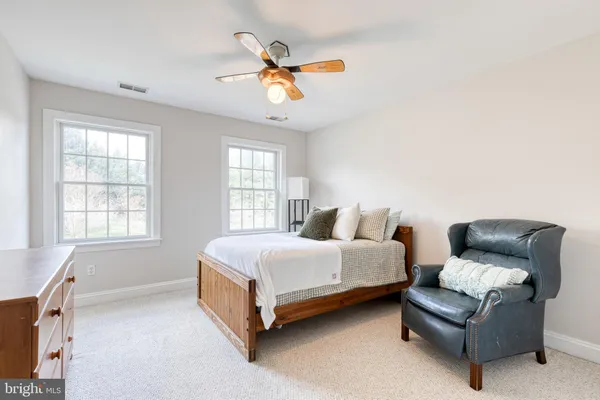 a bedroom with a bed couch and window