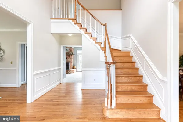 a view of entryway and hall with wooden floor