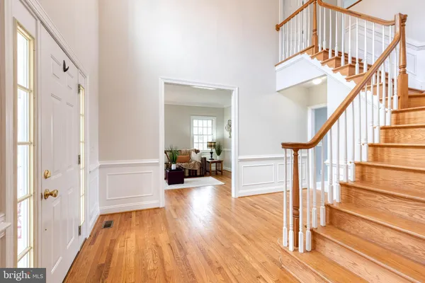 a view of entryway and hall with wooden floor