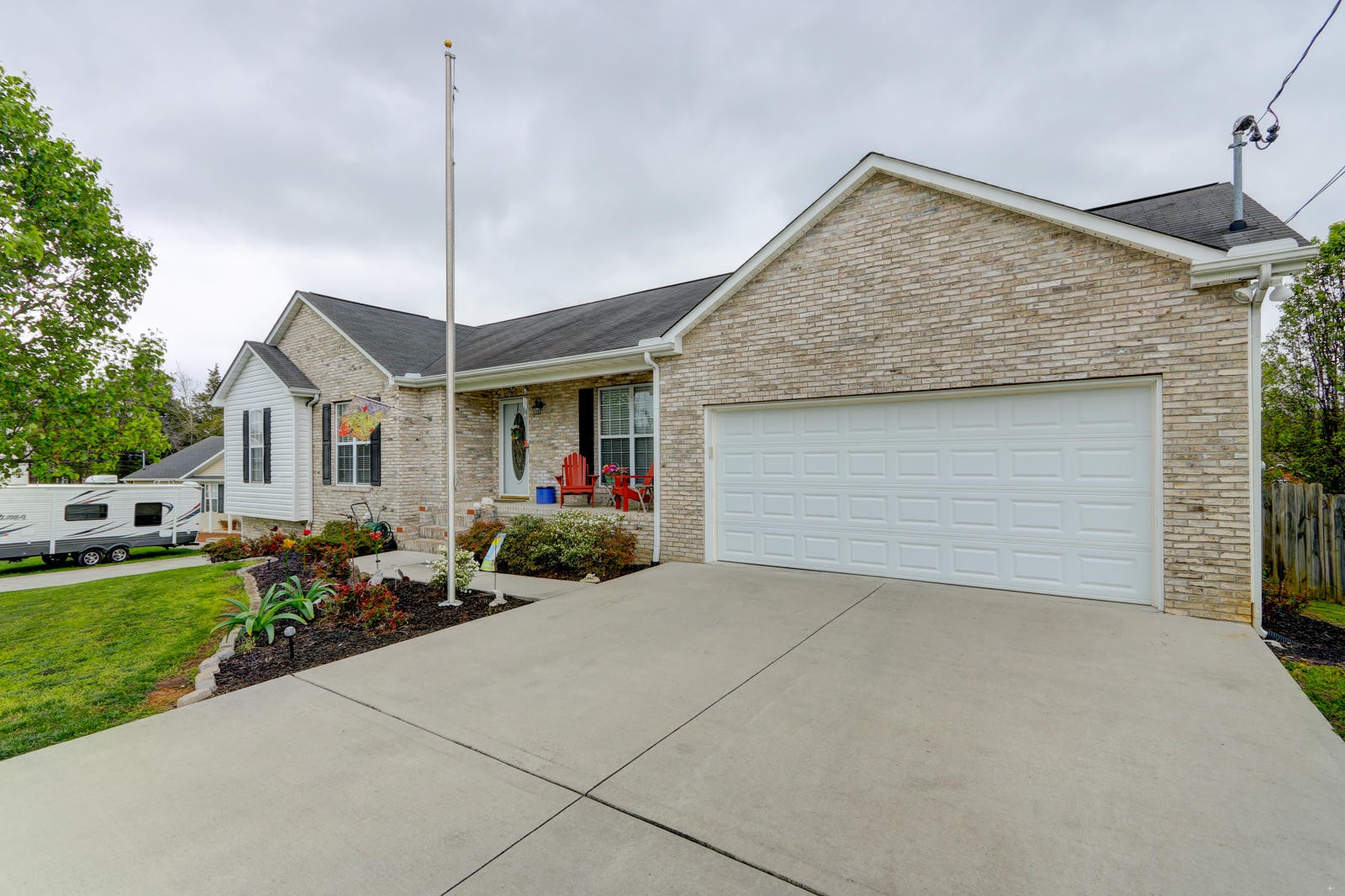 447 Pecan Circle Corryton, TN 37721 - Photo 1 of 28 a front view of a house with a garden and patio