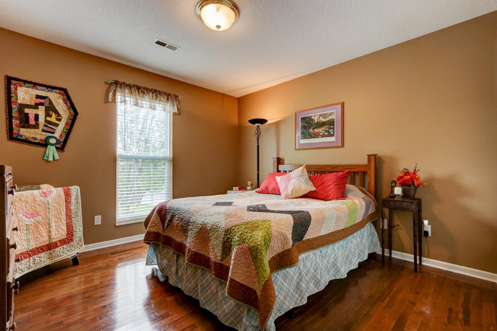 447 Pecan Circle Corryton, TN 37721 - Photo 19 of 28 a bedroom with a bed and wooden floor