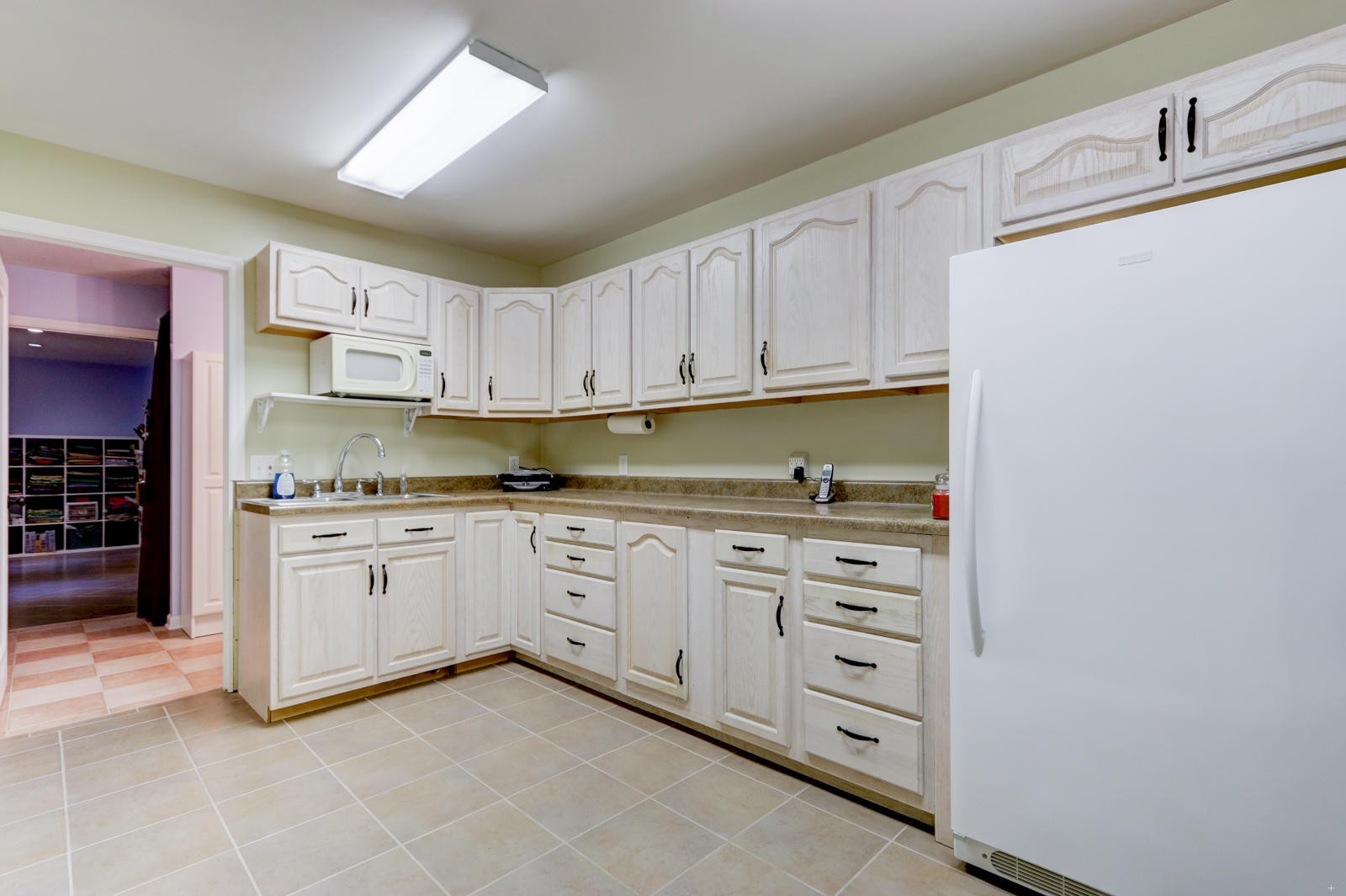 447 Pecan Circle Corryton, TN 37721 - Photo 24 of 28 a kitchen with granite countertop white cabinets and stainless steel appliances