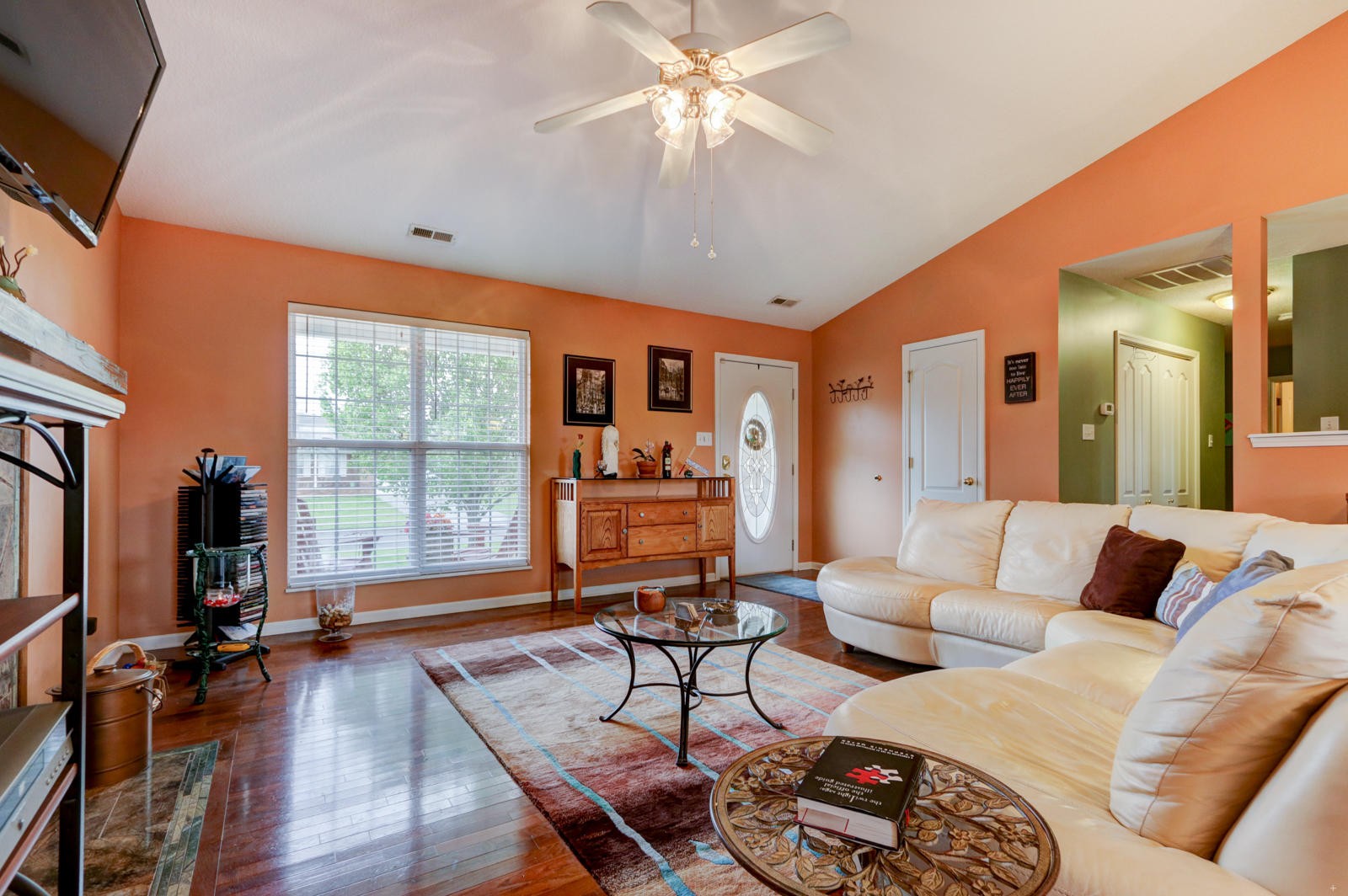 447 Pecan Circle Corryton, TN 37721 - Photo 3 of 28 a living room with furniture and a flat screen tv with wooden floor