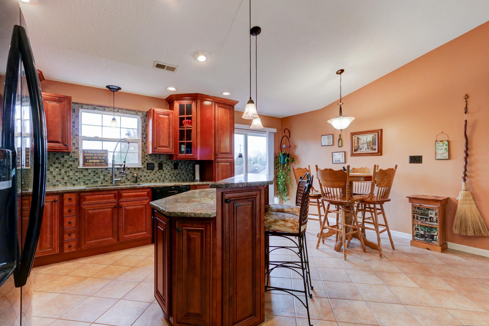 447 Pecan Circle Corryton, TN 37721 - Photo 9 of 28 a kitchen with stainless steel appliances granite countertop wooden cabinets a dining table and chairs