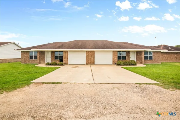 a view of house that has a yard