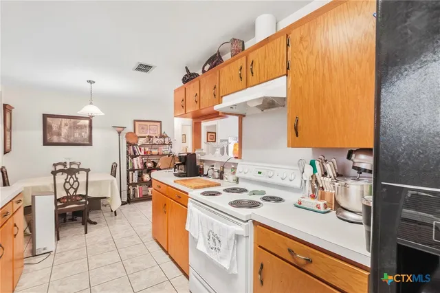 a kitchen with a sink a stove and cabinets