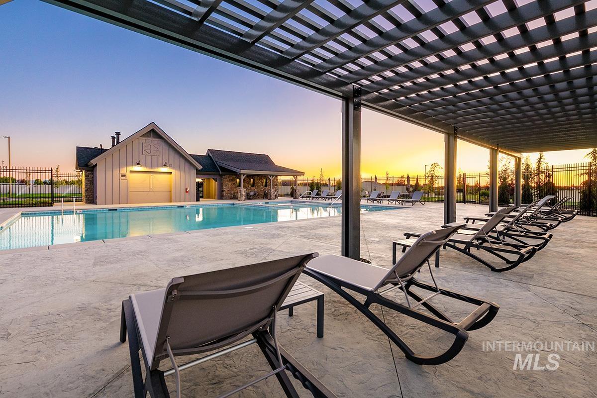 7151 South Skybreak Lane Meridian, ID 83642 - Photo 22 of 26 Pool at dusk featuring a patio, a community pool, and a pergola