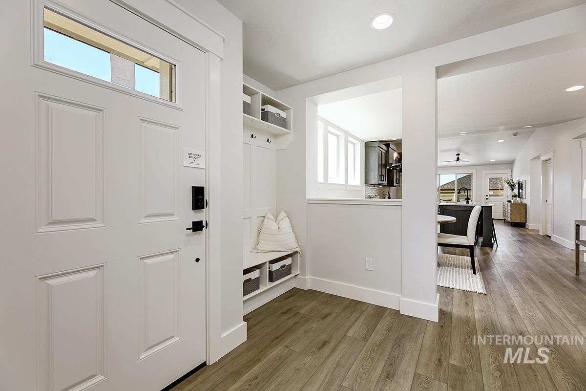7151 South Skybreak Lane Meridian, ID 83642 - Photo 2 of 26 Entryway featuring a built-in bench with storage, overhead shelving, and coat hooks