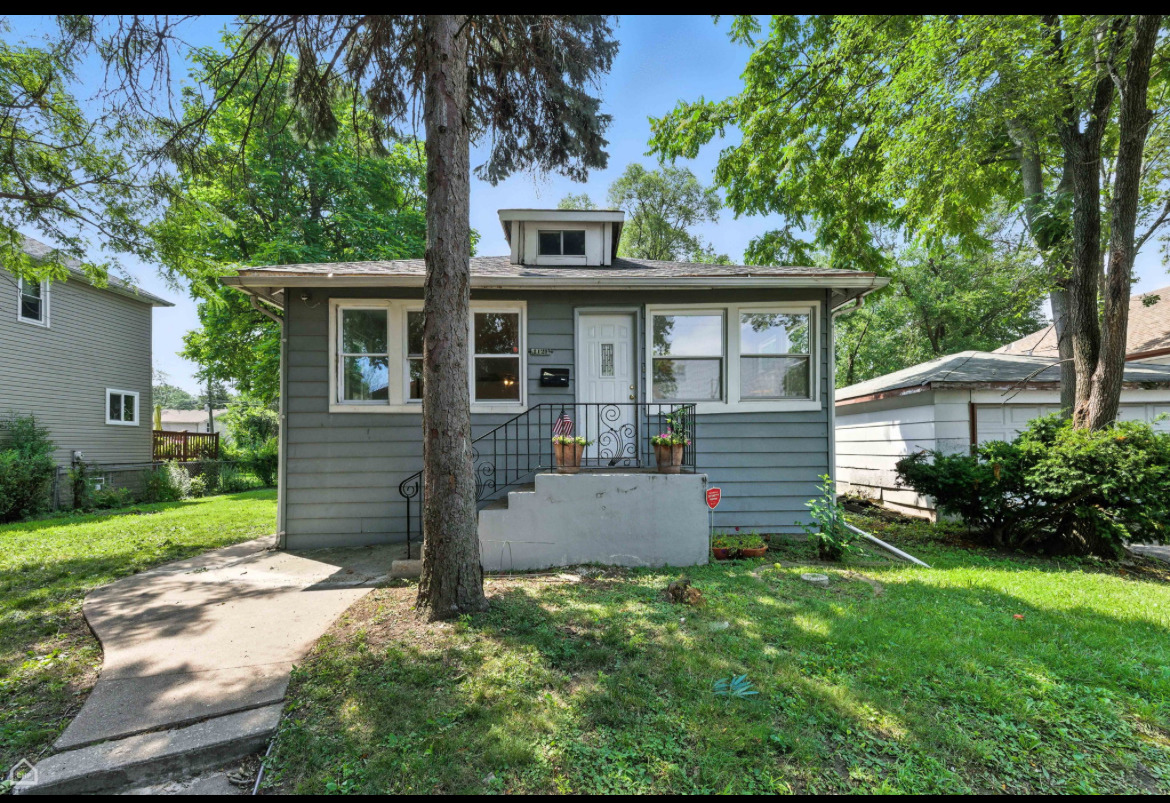 1121 West 104th Street Chicago, IL 60643 - Photo 17 of 17 front view of a house with a yard