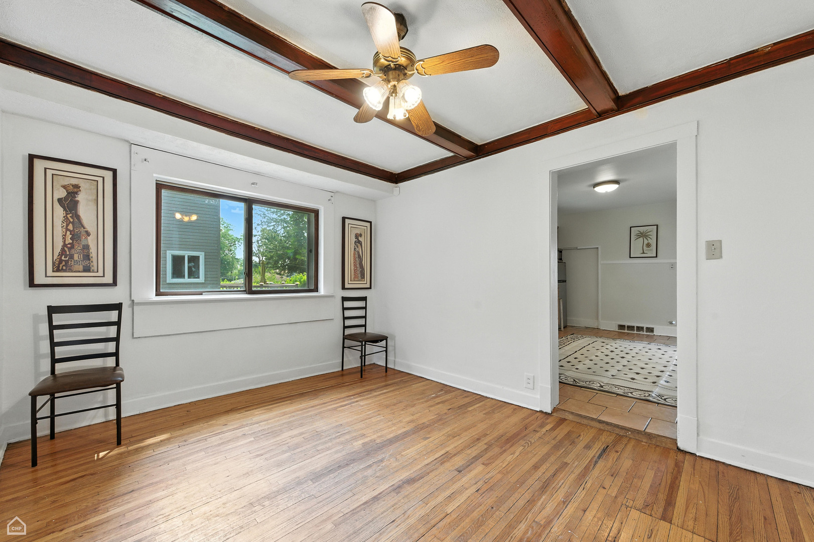 1121 West 104th Street Chicago, IL 60643 - Photo 5 of 17 a view of an empty room with window and wooden floor
