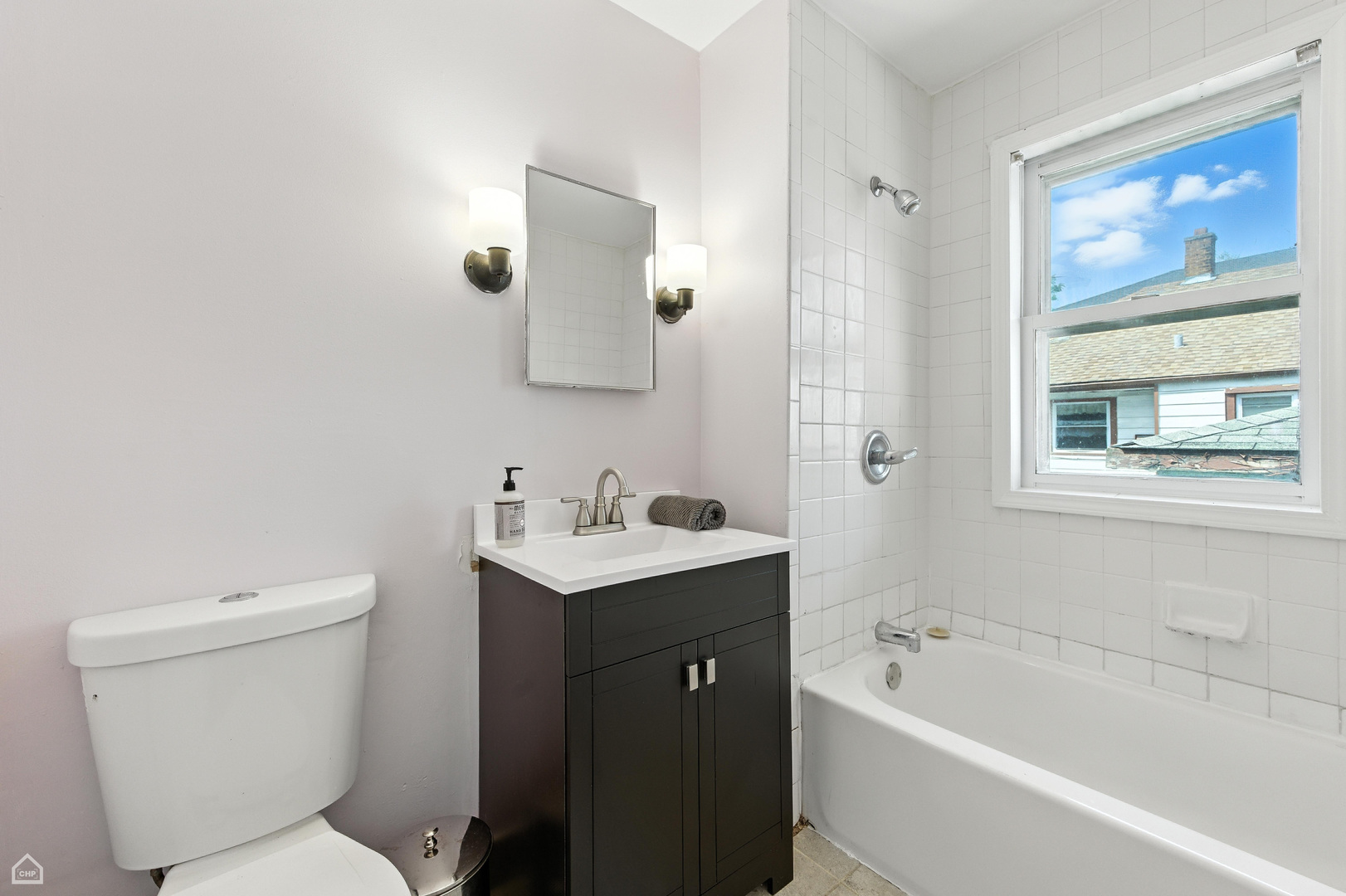 1121 West 104th Street Chicago, IL 60643 - Photo 7 of 17 a bathroom with a toilet a sink a mirror a bathtub and vanity