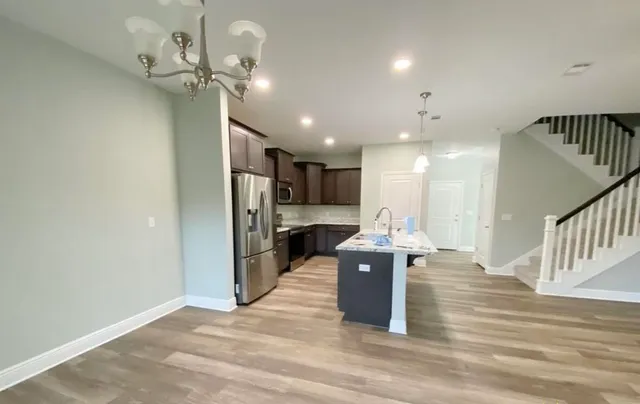 a view of a kitchen and living room with a chandelier
