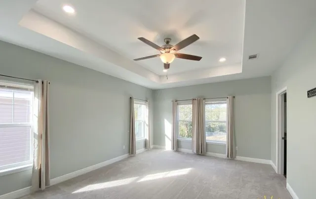 a view of a livingroom with a ceiling fan and window