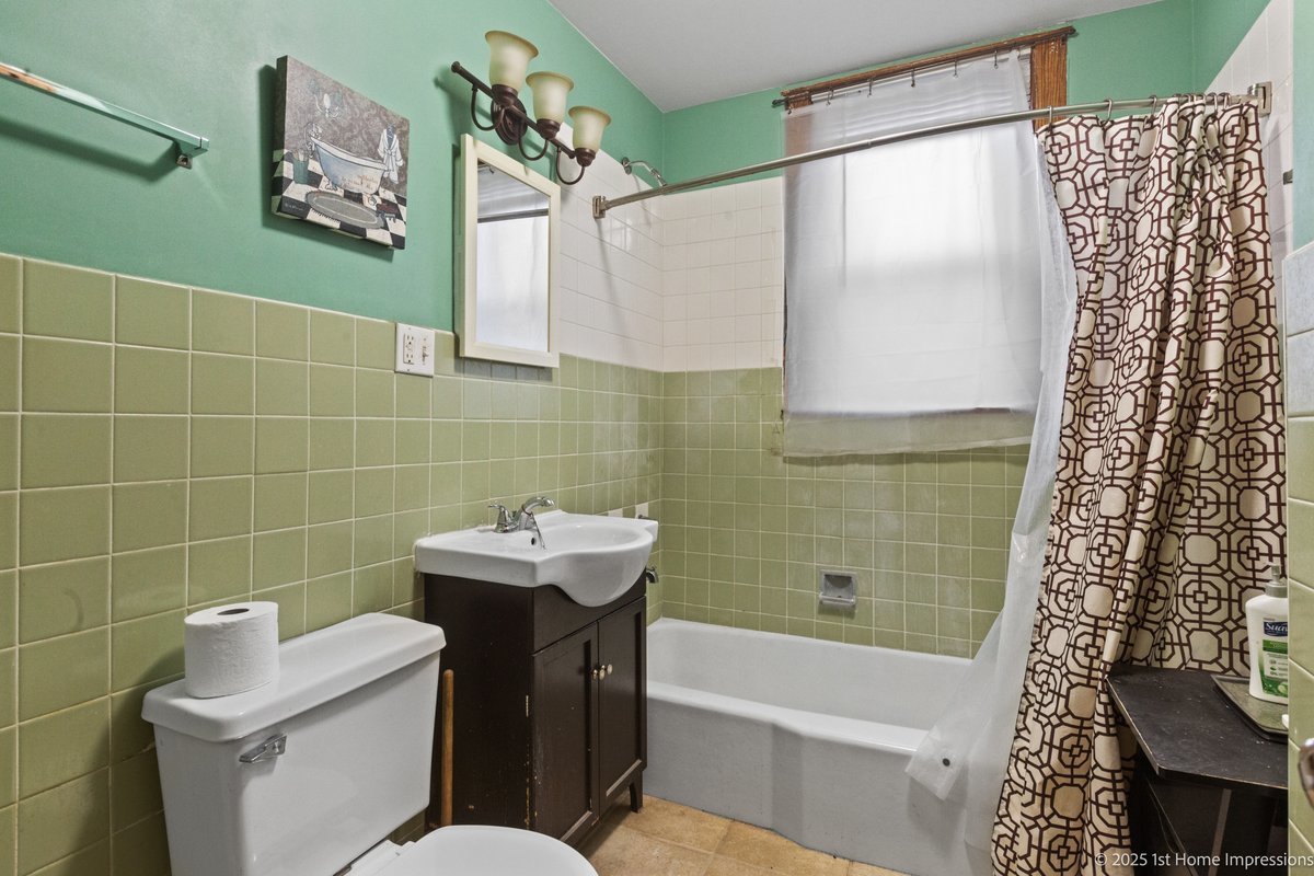 1833 South Troy Street Chicago, IL 60623 - Photo 12 of 18 a bathroom with a sink a toilet and shower