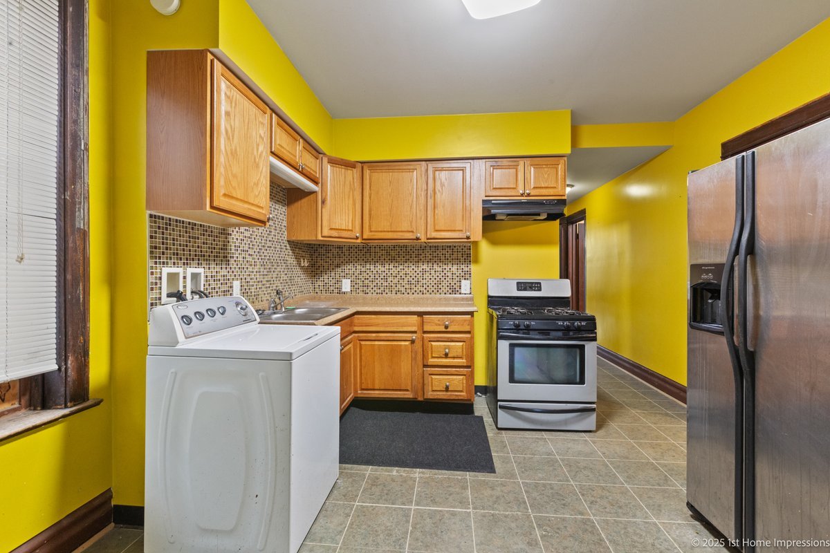 1833 South Troy Street Chicago, IL 60623 - Photo 14 of 18 a kitchen with stainless steel appliances granite countertop a refrigerator and a stove