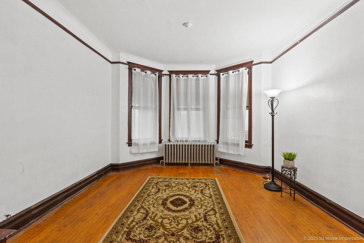 1833 South Troy Street Chicago, IL 60623 - Photo 5 of 18 a room with window and rug