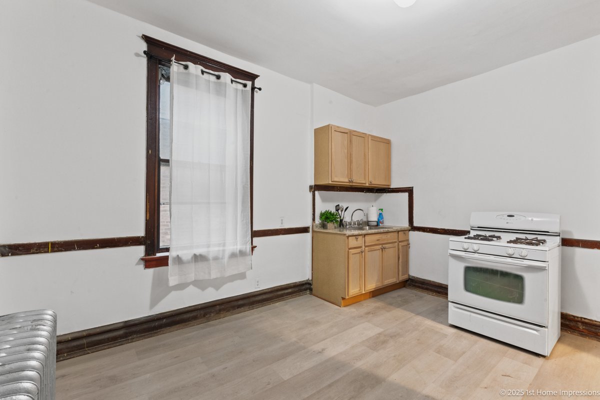 1833 South Troy Street Chicago, IL 60623 - Photo 6 of 18 a room with a stove and a mirror