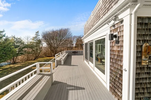 a view of a balcony with dining table and chairs with wooden floor
